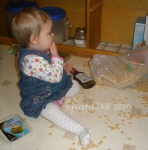 Baby Molly eating cereal spilled all over the floor.