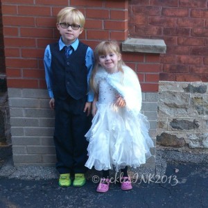 Ben and Molly in formal clothing against a brick wall. (Super cute kids formal outfits)